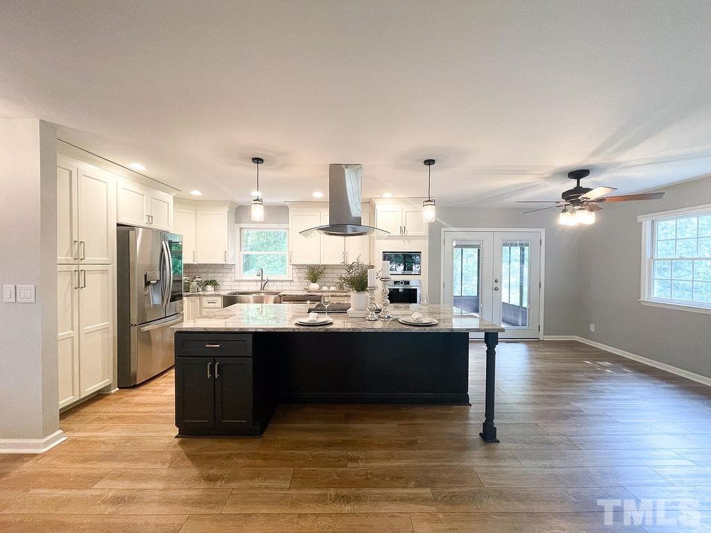 6700 Laurdane Road Raleigh, NC 27613 - Photo 3 of 25 a view of a kitchen with stainless steel appliances kitchen island granite countertop a refrigerator and a stove top oven