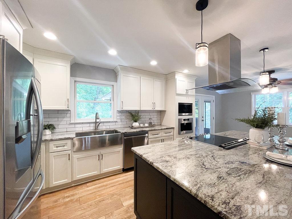 6700 Laurdane Road Raleigh, NC 27613 - Photo 6 of 25 a kitchen with stainless steel appliances granite countertop sink stove top oven and refrigerator