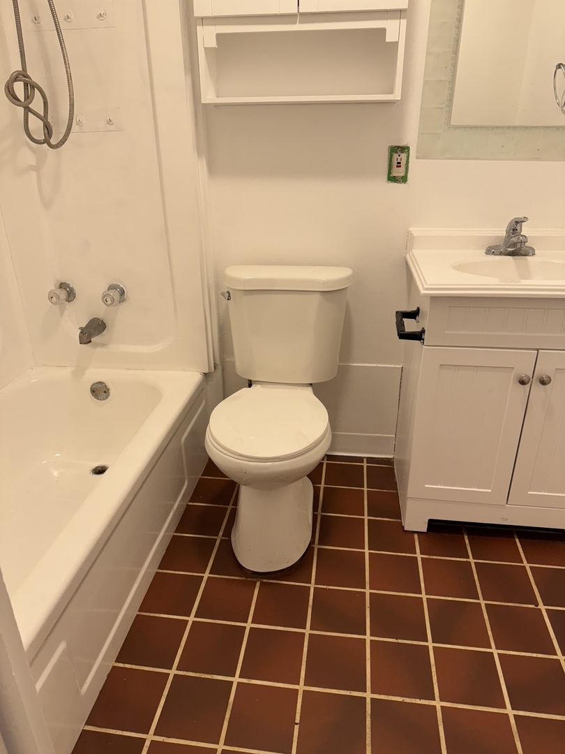 106 Valley View Drive, Unit 106 McHenry, IL 60050 - Photo 3 of 7 a bathroom with a sink a toilet and a mirror