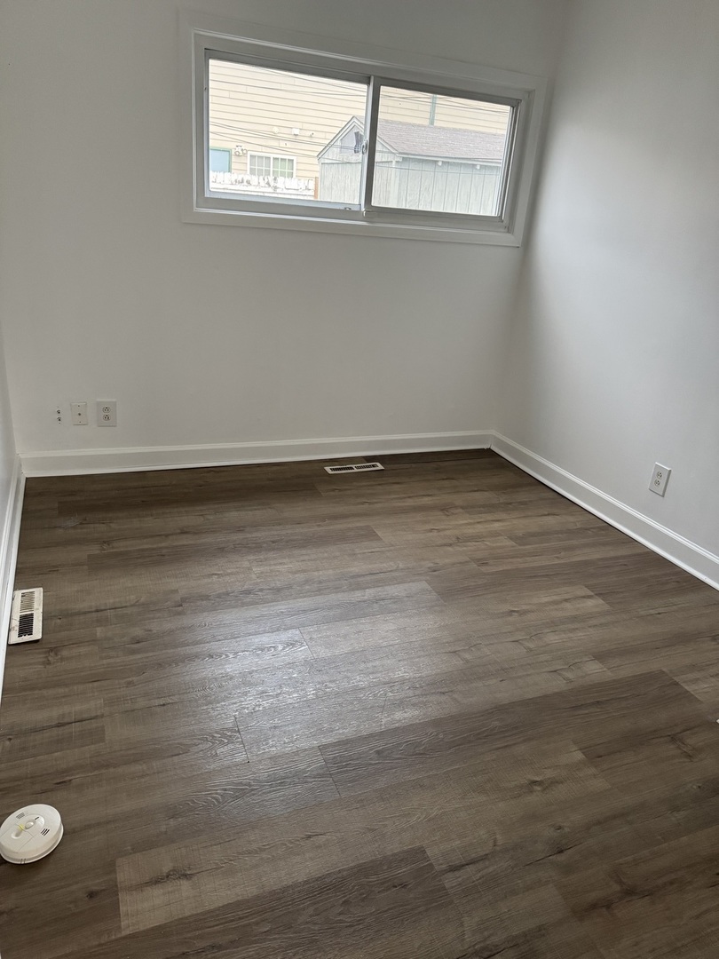 106 Valley View Drive, Unit 106 McHenry, IL 60050 - Photo 7 of 7 a view of a room with wooden floor and window
