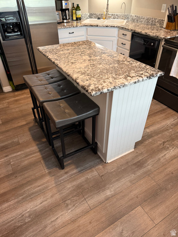 14797 South Chandlerpoint Way Draper, UT 84020 - Photo 11 of 33 Kitchen island featuring a patterned countertop and white beadboard paneling