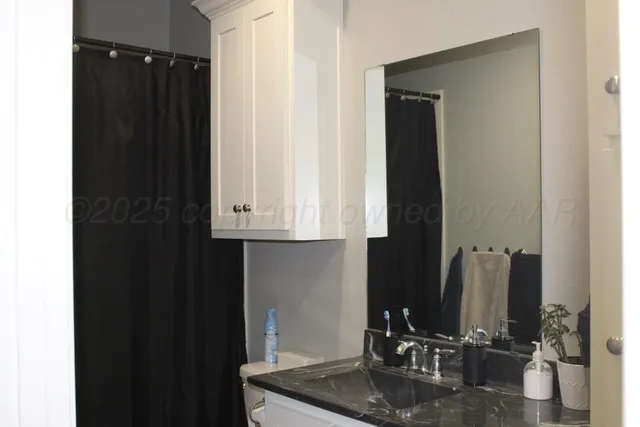 a bathroom with a sink a mirror and cabinets