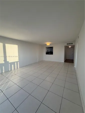 a living room with a large window and furniture