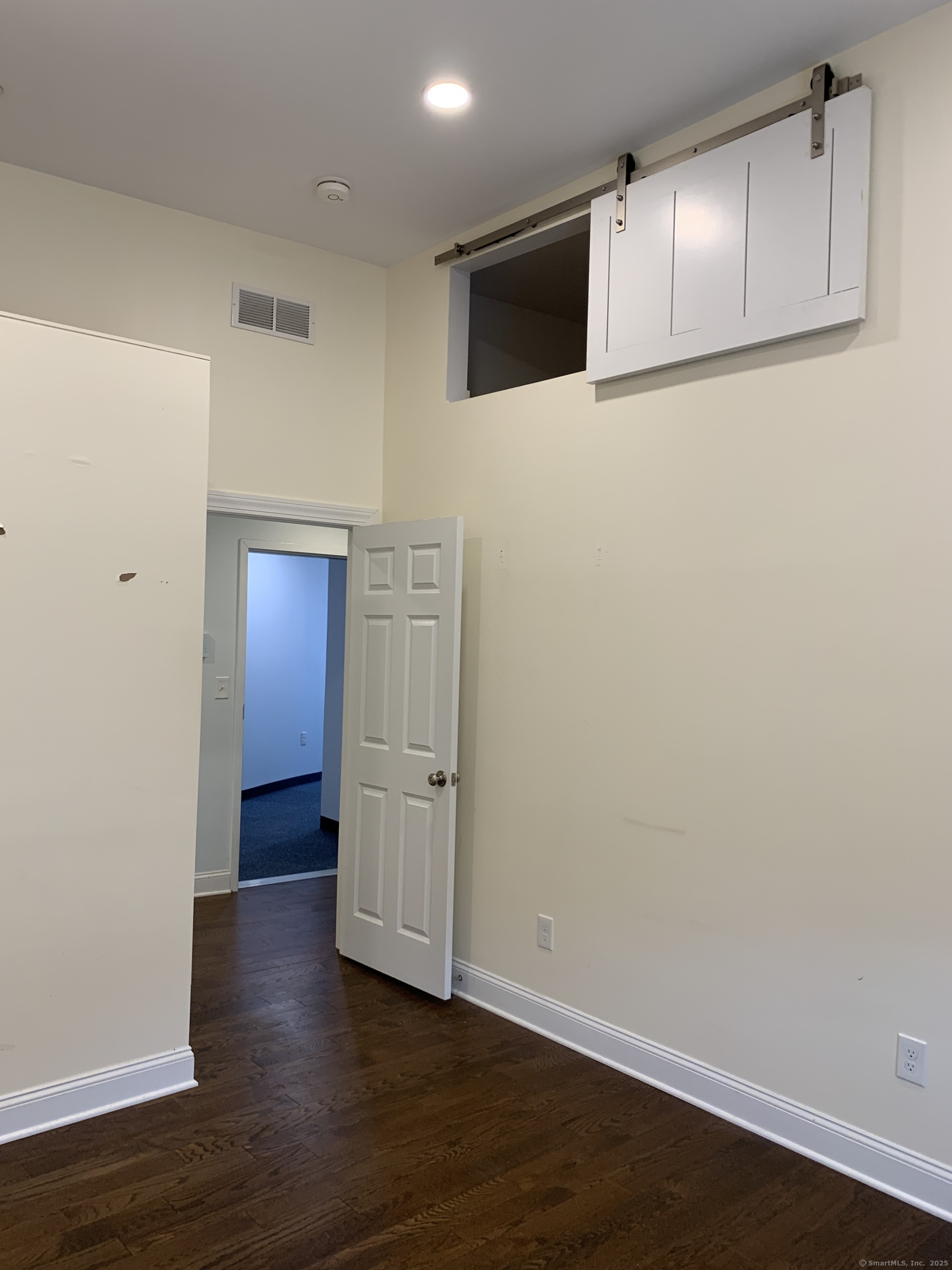 66 Cedar Street, Unit 2 Norwalk, CT 06854 - Photo 14 of 23 a view of an empty room with wooden floor