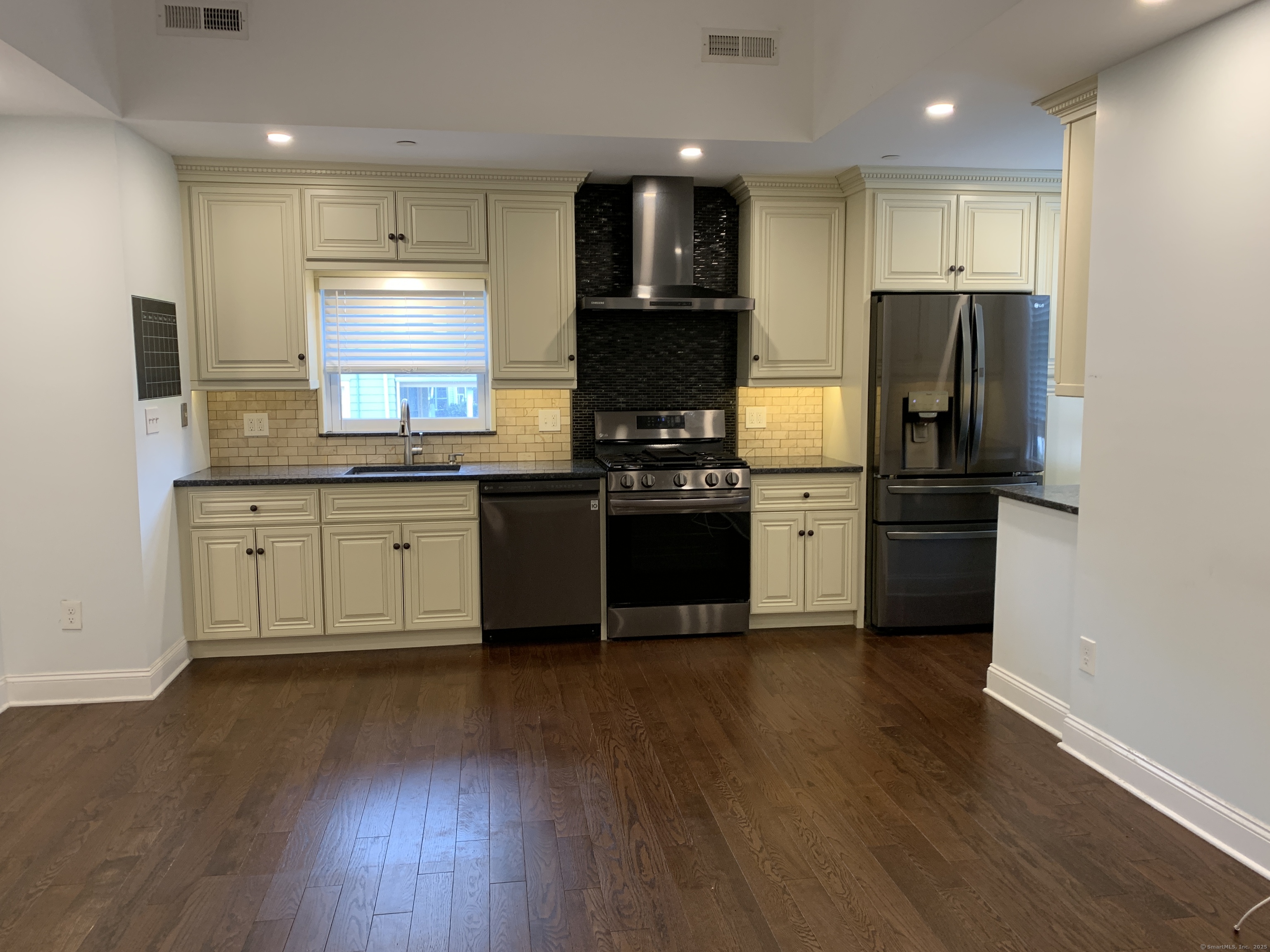 66 Cedar Street, Unit 2 Norwalk, CT 06854 - Photo 16 of 23 a kitchen with stainless steel appliances granite countertop a refrigerator and a stove top oven