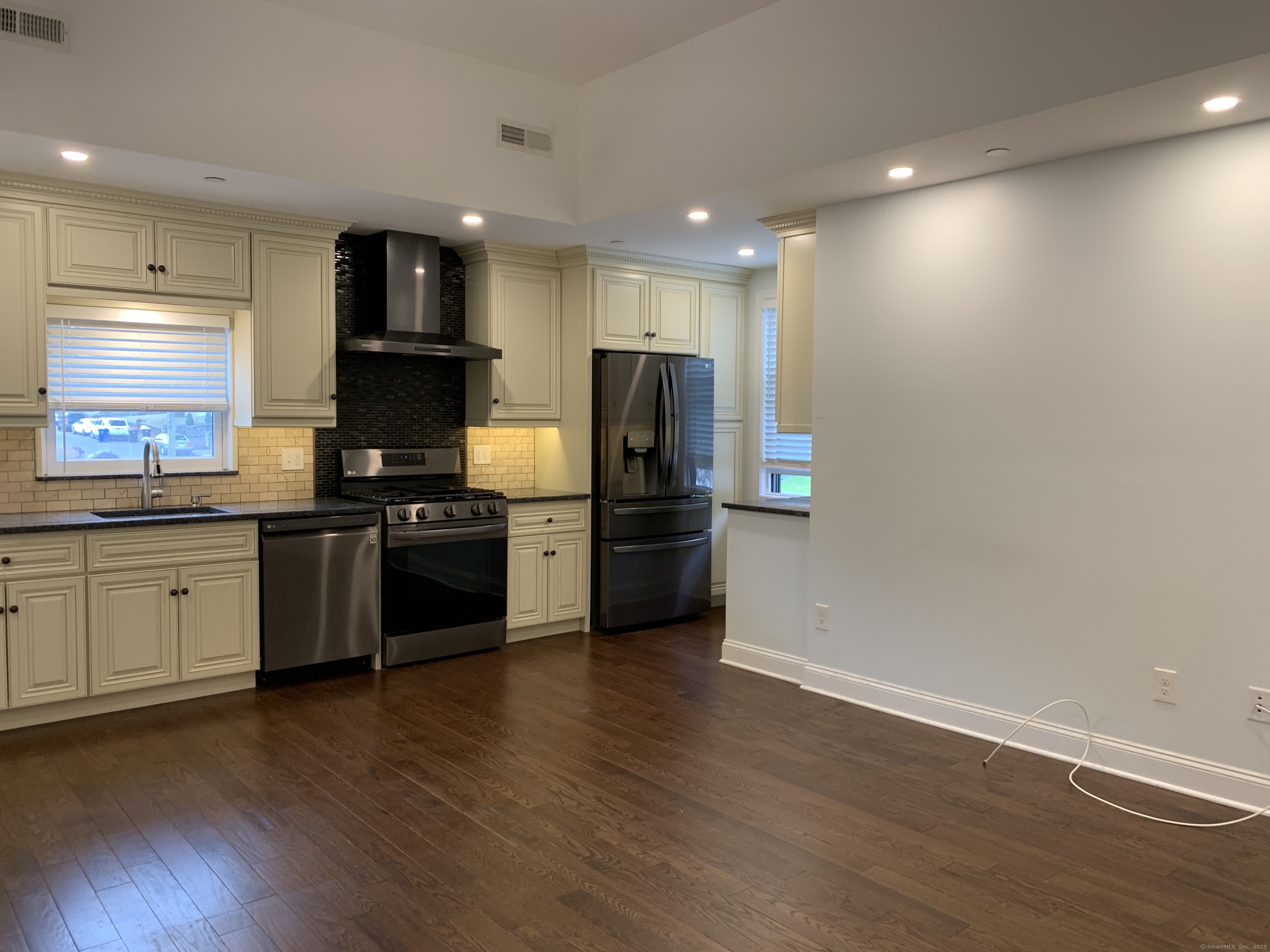 66 Cedar Street, Unit 2 Norwalk, CT 06854 - Photo 17 of 23 a kitchen with granite countertop a refrigerator and a stove top oven