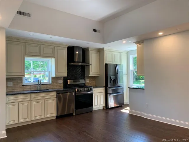 a kitchen with stainless steel appliances a stove cabinets and a refrigerator