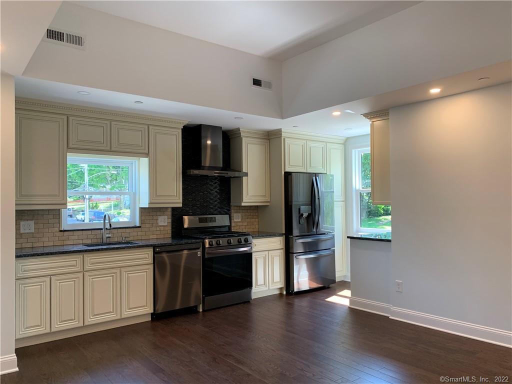 66 Cedar Street, Unit 2 Norwalk, CT 06854 - Photo 2 of 23 a kitchen with stainless steel appliances a stove cabinets and a refrigerator