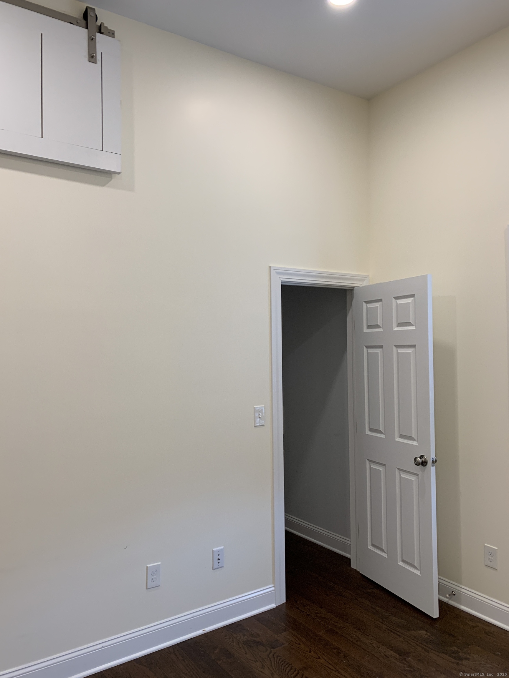 66 Cedar Street, Unit 2 Norwalk, CT 06854 - Photo 21 of 23 an empty room with wooden floor