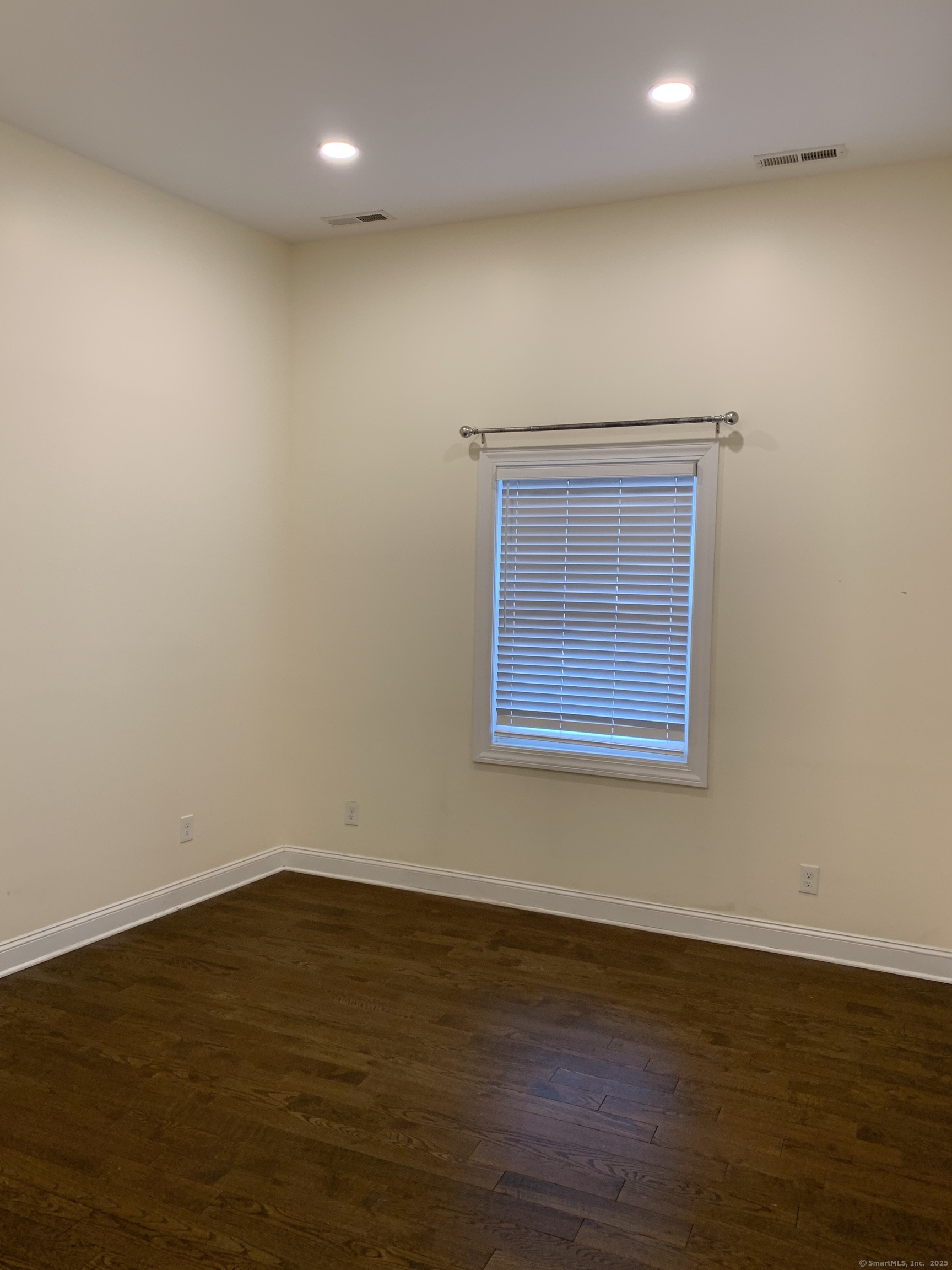 66 Cedar Street, Unit 2 Norwalk, CT 06854 - Photo 22 of 23 a view of empty room with wooden floor and fan