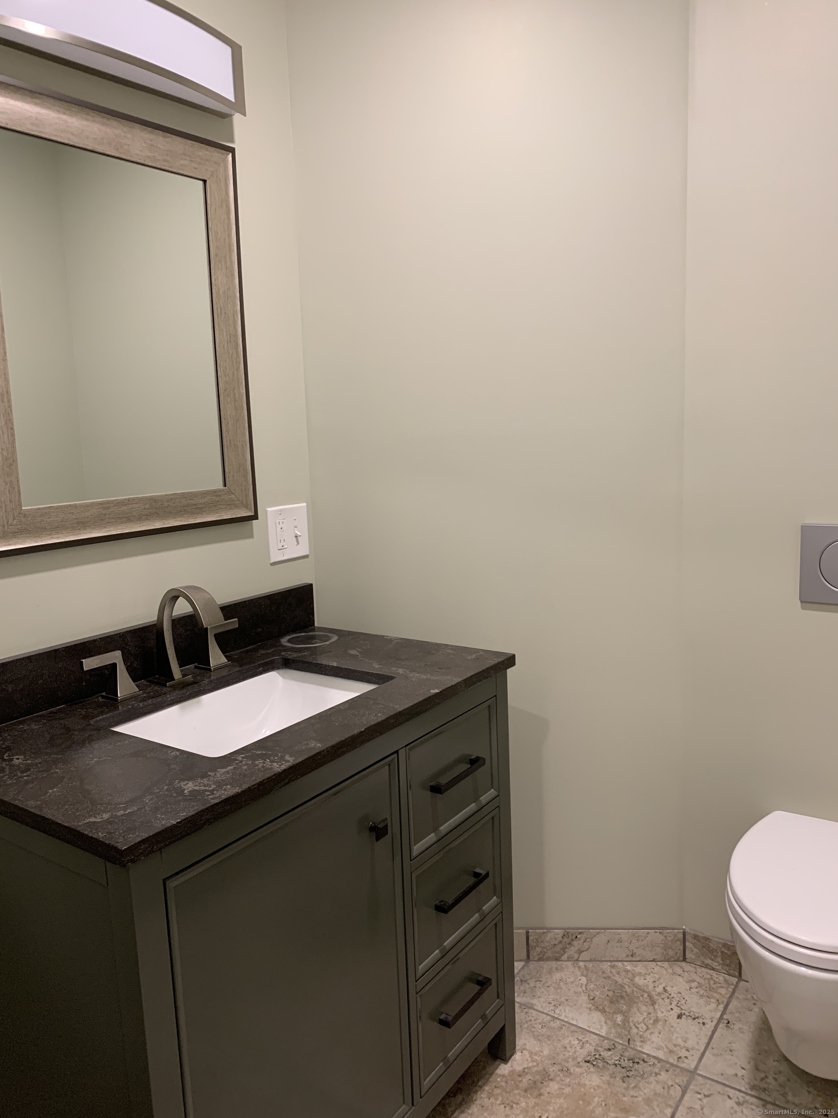 66 Cedar Street, Unit 2 Norwalk, CT 06854 - Photo 23 of 23 a bathroom with a granite countertop sink and a toilet