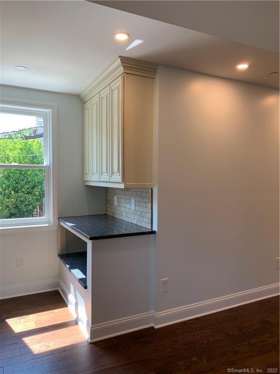 66 Cedar Street, Unit 2 Norwalk, CT 06854 - Photo 3 of 23 an empty room with wooden floor and windows