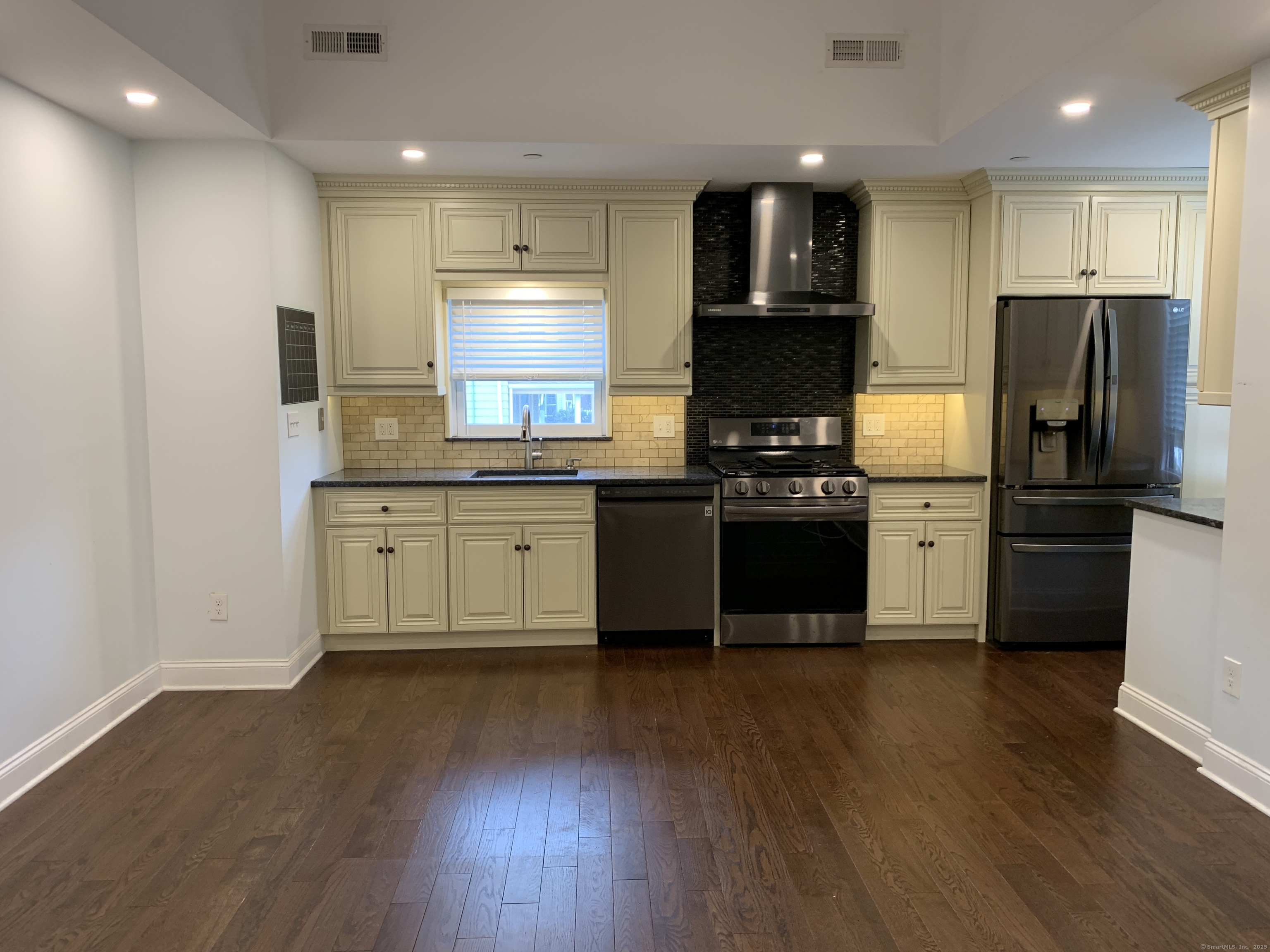 66 Cedar Street, Unit 2 Norwalk, CT 06854 - Photo 9 of 23 a kitchen with stainless steel appliances granite countertop a stove a sink and a refrigerator