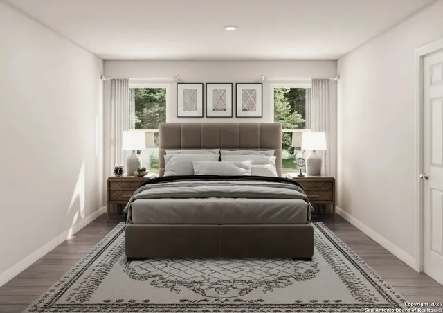 a bed sitting in a bedroom next to a window