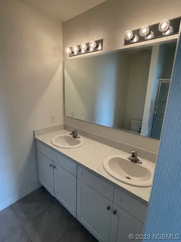 a bathroom with a glass shower door