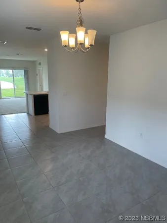 a view of a hallway with a chandelier