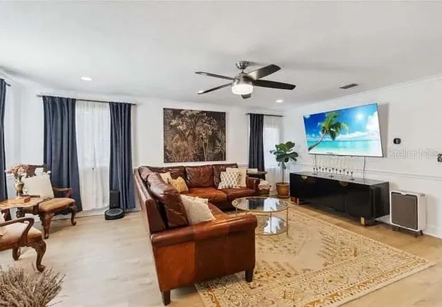 a living room with furniture a fireplace and a flat screen tv