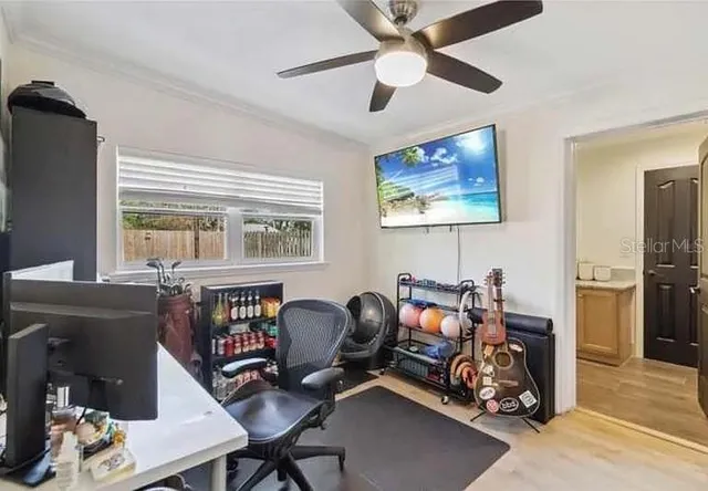 a view of a workspace with furniture and a window