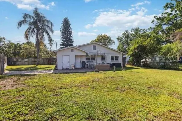 a front view of house with yard and swimming pool