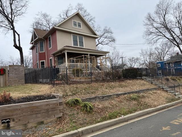 2630 Brentwood Road Northeast Washington, DC 20018 - Photo 3 of 10 a view of a white house next to a yard with large trees