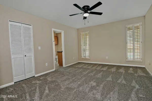a view of a big room with wooden floor and a ceiling fan