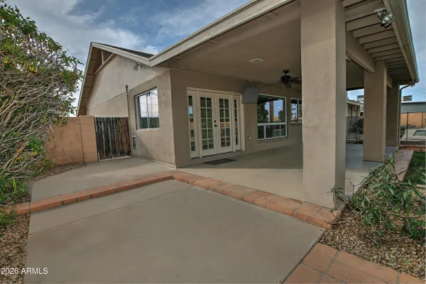 a view of a house with backyard and porch