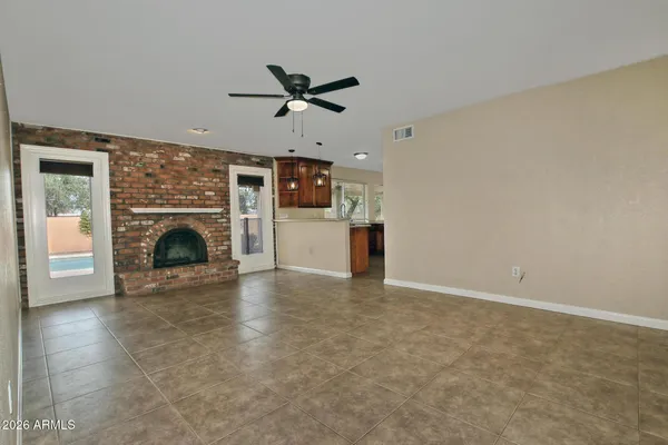 a view of empty room with a fireplace