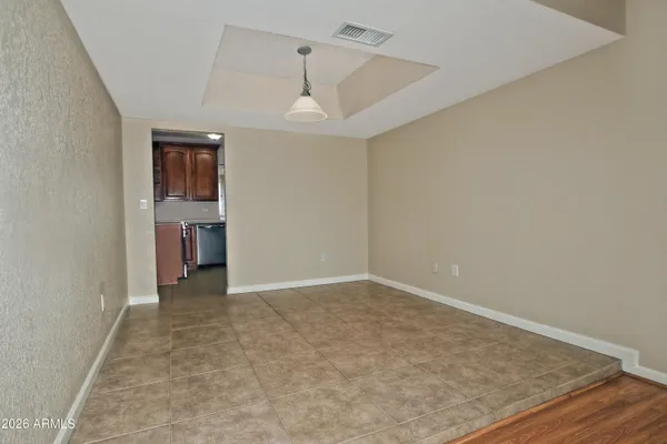 an empty room with closet and windows