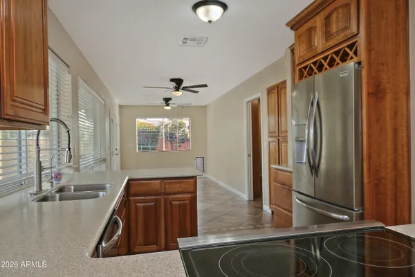 a kitchen with stainless steel appliances granite countertop a sink refrigerator and microwave