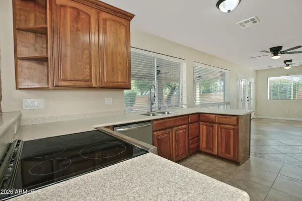 a kitchen with stainless steel appliances granite countertop a sink stove and cabinets