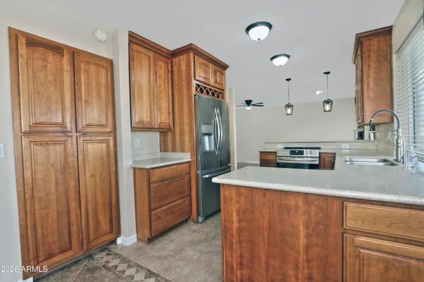 a kitchen with stainless steel appliances a refrigerator and cabinets