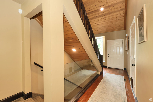 3104 East High Danish Road Sandy, UT 84093 - Photo 4 of 36 Entryway featuring wood-finish flooring, a paneled front door, and a wood-paneled ceiling