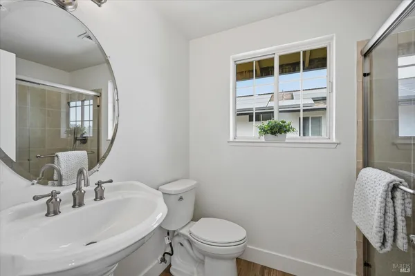 a bathroom with a granite countertop toilet a sink and bathtub