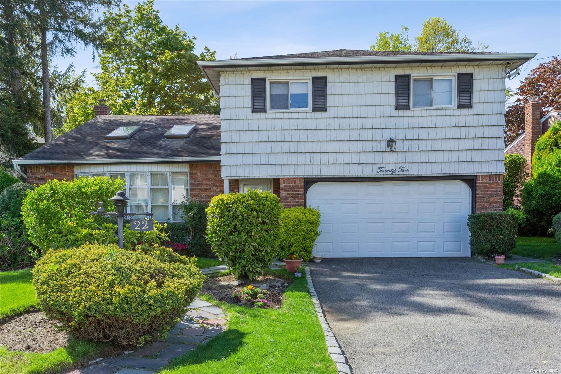 22 Steven Drive Hewlett, NY 11557 - Photo 1 of 1 a front view of a house with garden