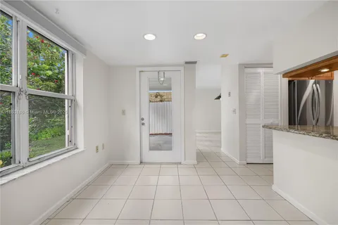 a view of a kitchen with a closet and windows