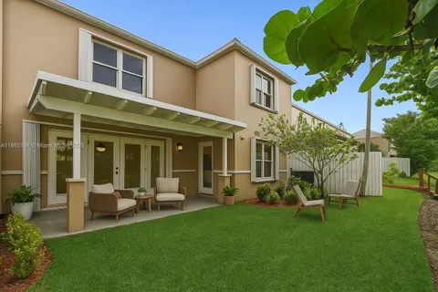 a view of a house with a backyard patio and swimming pool
