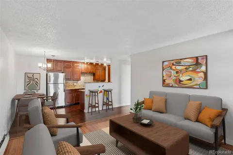 a living room with furniture a rug and a table