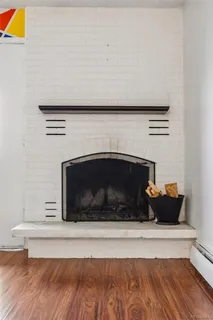 a living room with a fireplace and a wooden floor