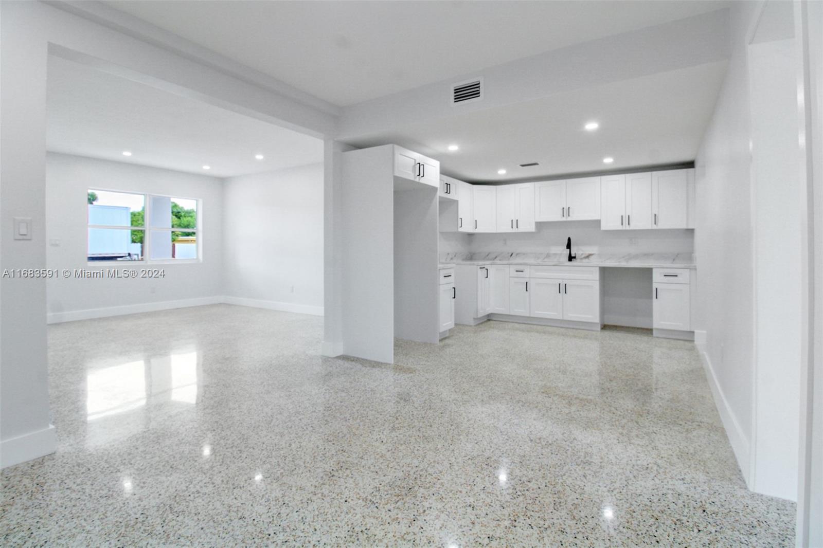 7120 Southwest 9th Street Miami, FL 33144 - Photo 11 of 25 a view of a kitchen with a sink and dishwasher a refrigerator with wooden floor