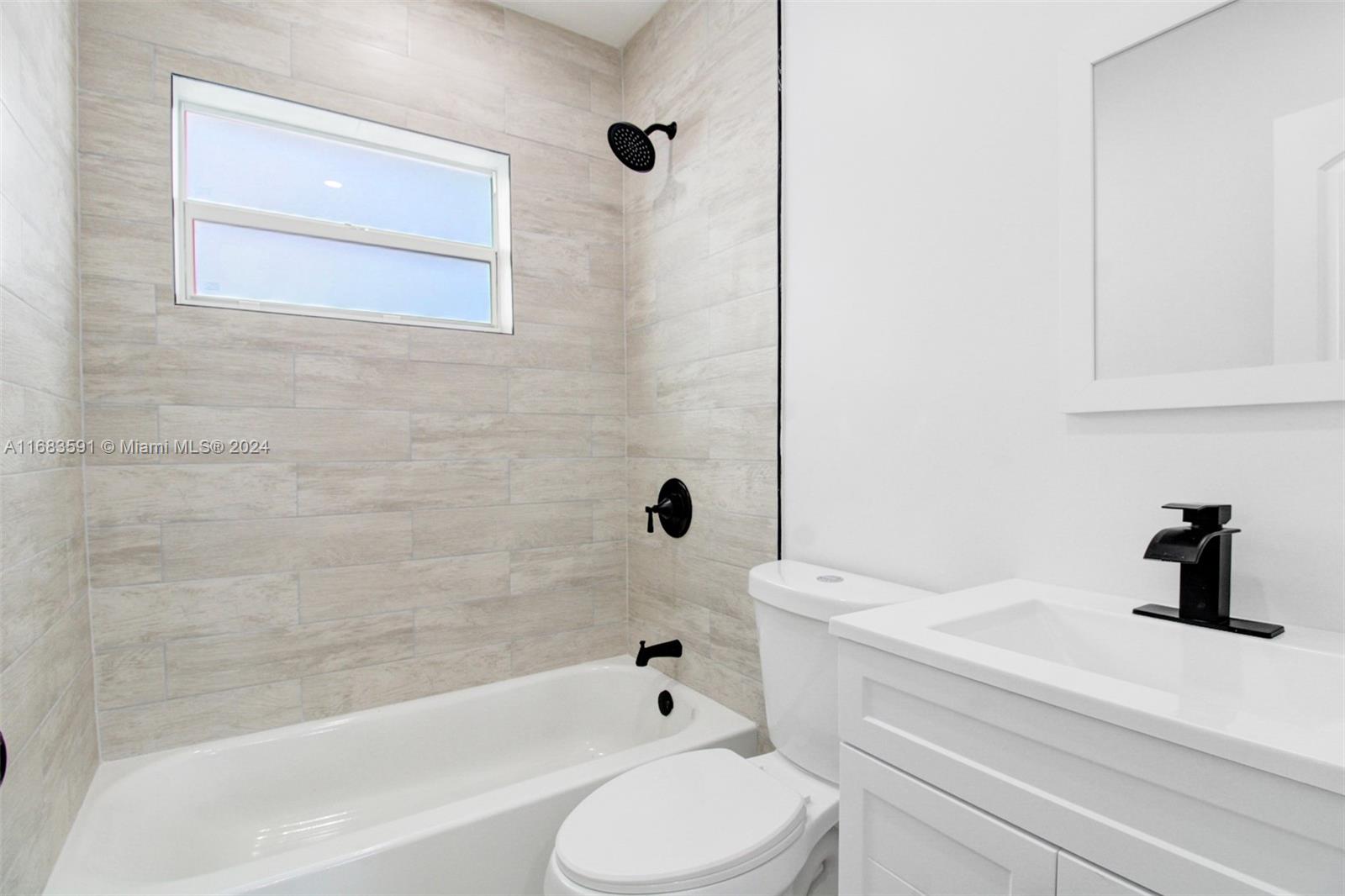 7120 Southwest 9th Street Miami, FL 33144 - Photo 17 of 25 a bathroom with a sink a toilet and a bathtub