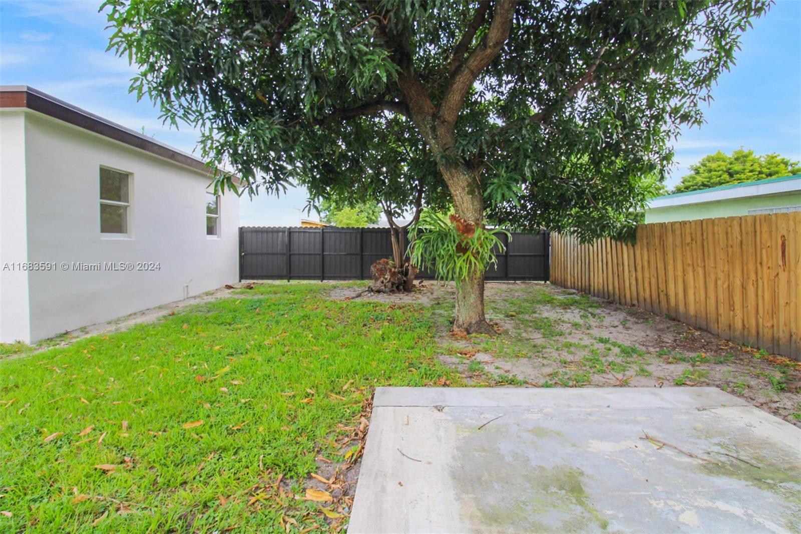 7120 Southwest 9th Street Miami, FL 33144 - Photo 21 of 25 a view of a backyard with a small cabin and a chair