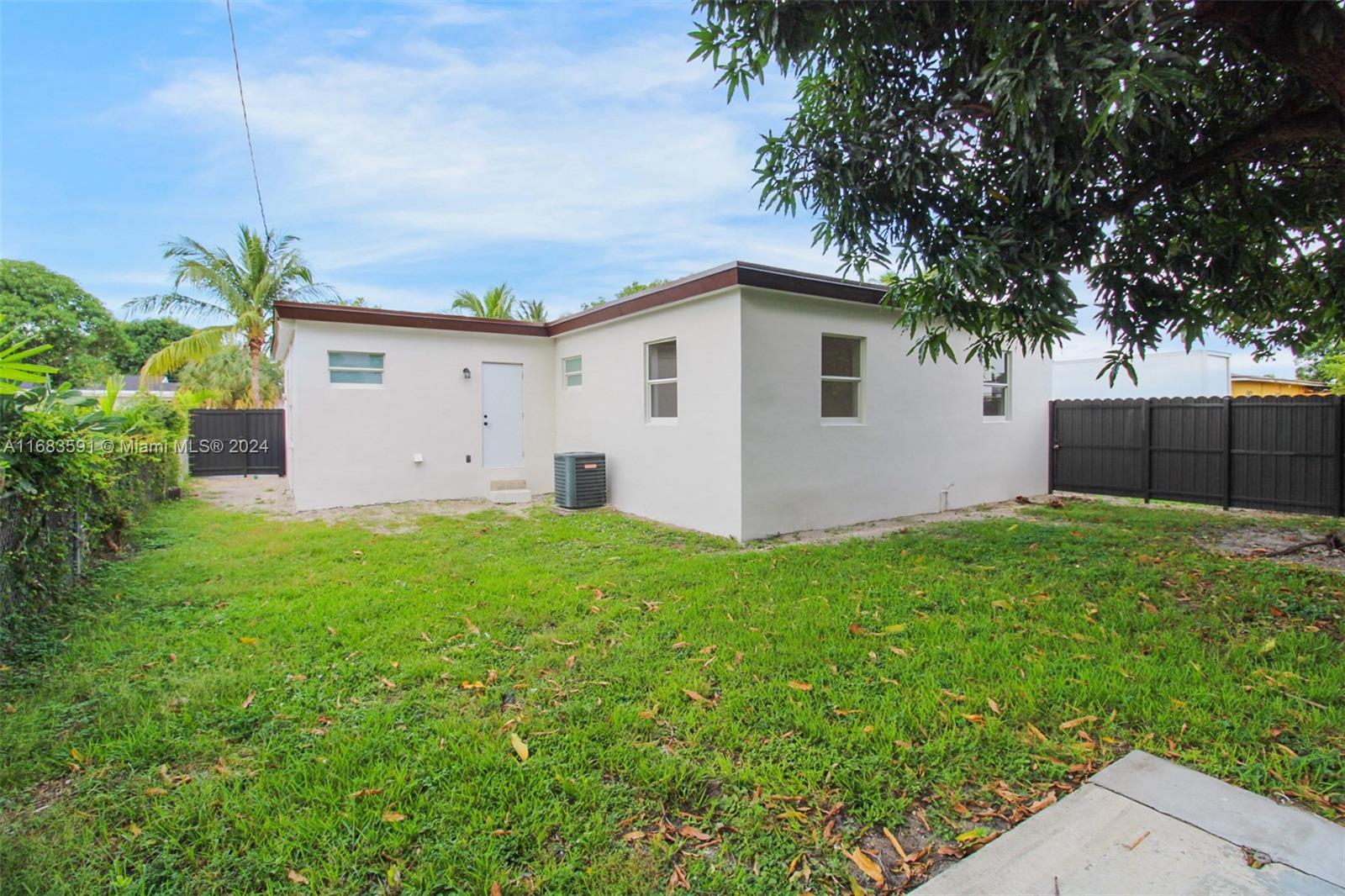 7120 Southwest 9th Street Miami, FL 33144 - Photo 22 of 25 a view of a house with a yard