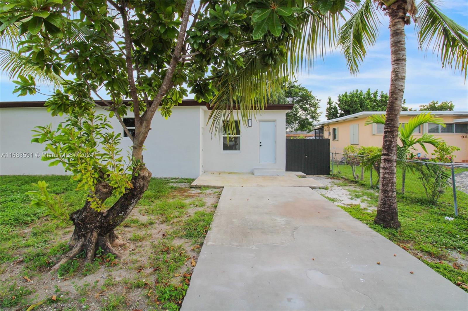 7120 Southwest 9th Street Miami, FL 33144 - Photo 23 of 25 a front view of a house with a yard and garage