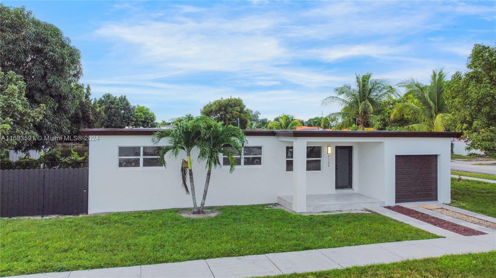 7120 Southwest 9th Street Miami, FL 33144 - Photo 3 of 25 a front view of house with yard and green space