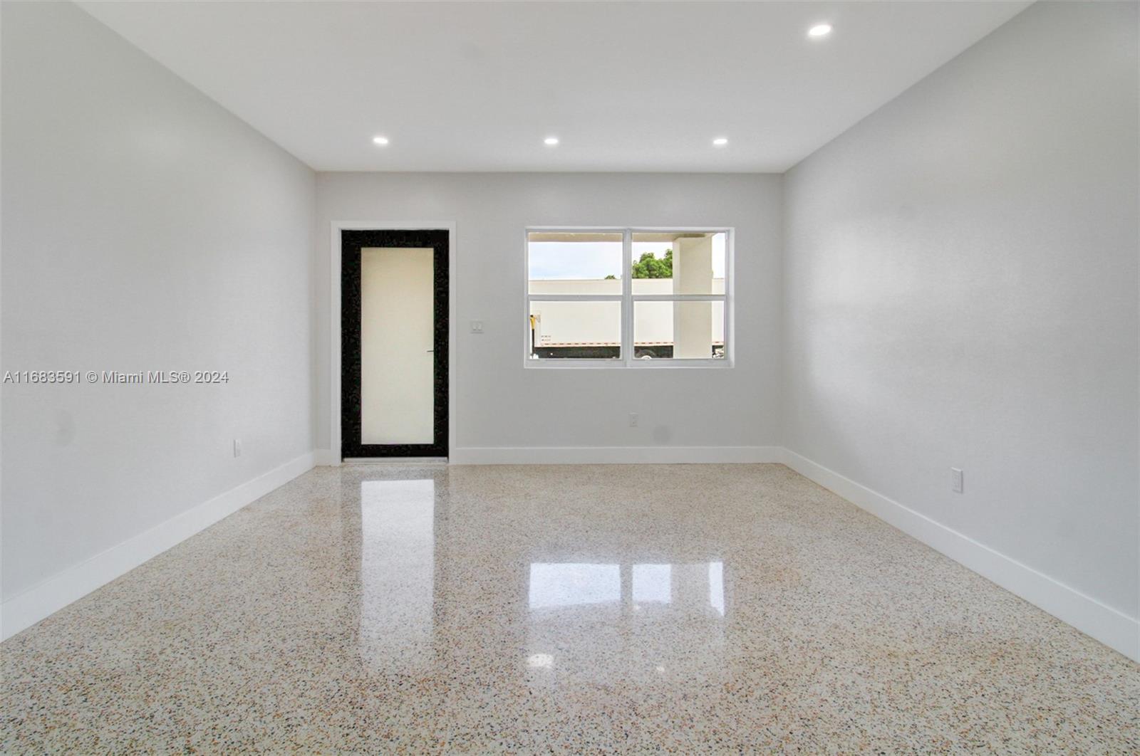 7120 Southwest 9th Street Miami, FL 33144 - Photo 5 of 25 an empty room with windows