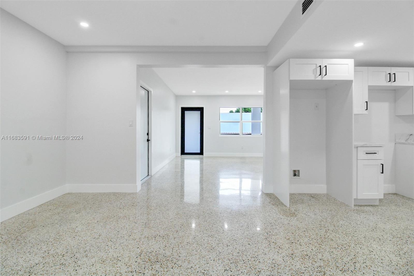 7120 Southwest 9th Street Miami, FL 33144 - Photo 6 of 25 a view of a hallway with wooden floor and windows