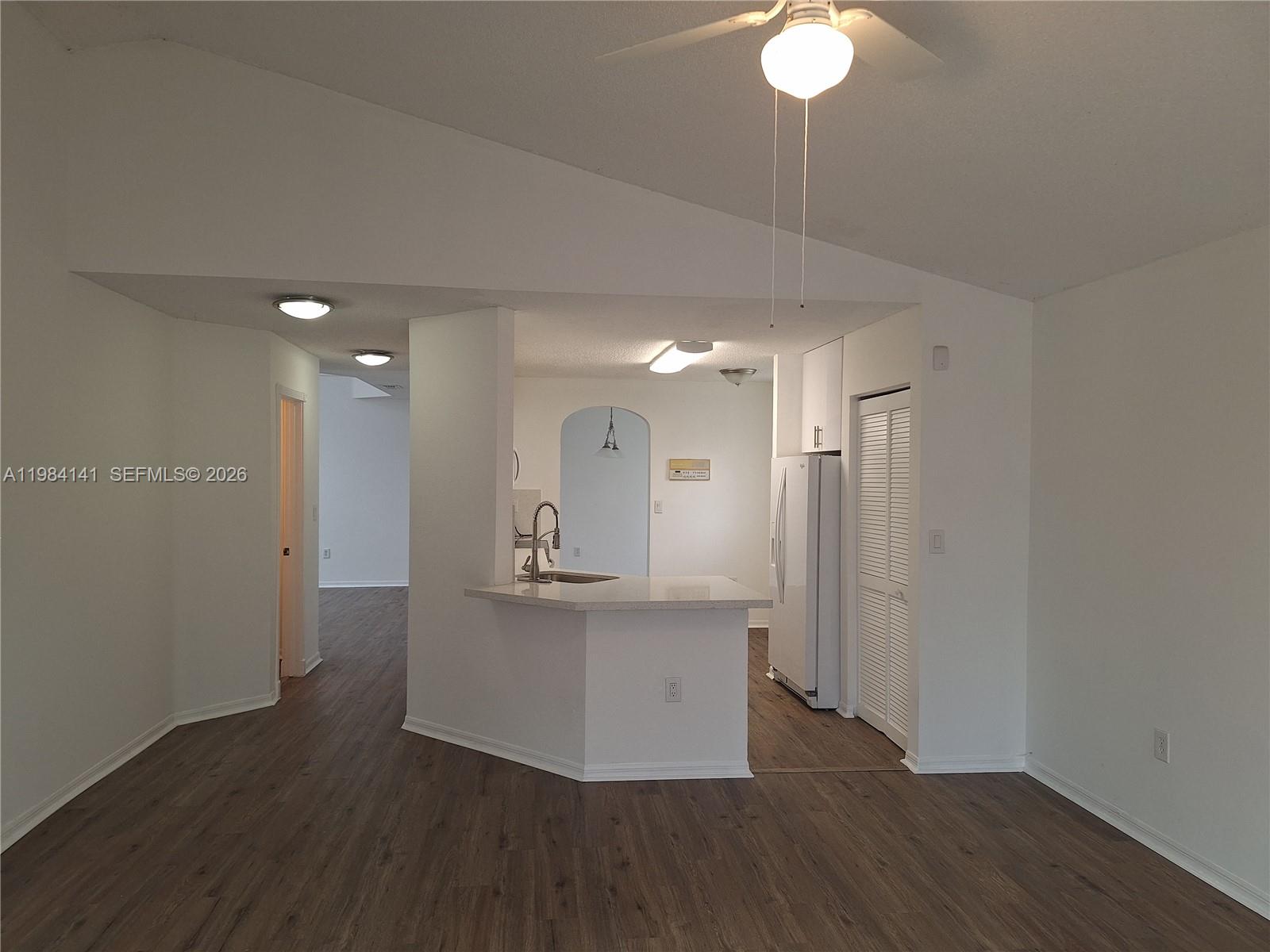 446 Lakeside Circle Sunrise, FL 33326 - Photo 11 of 13 a view of a kitchen with wooden floor and a chandelier
