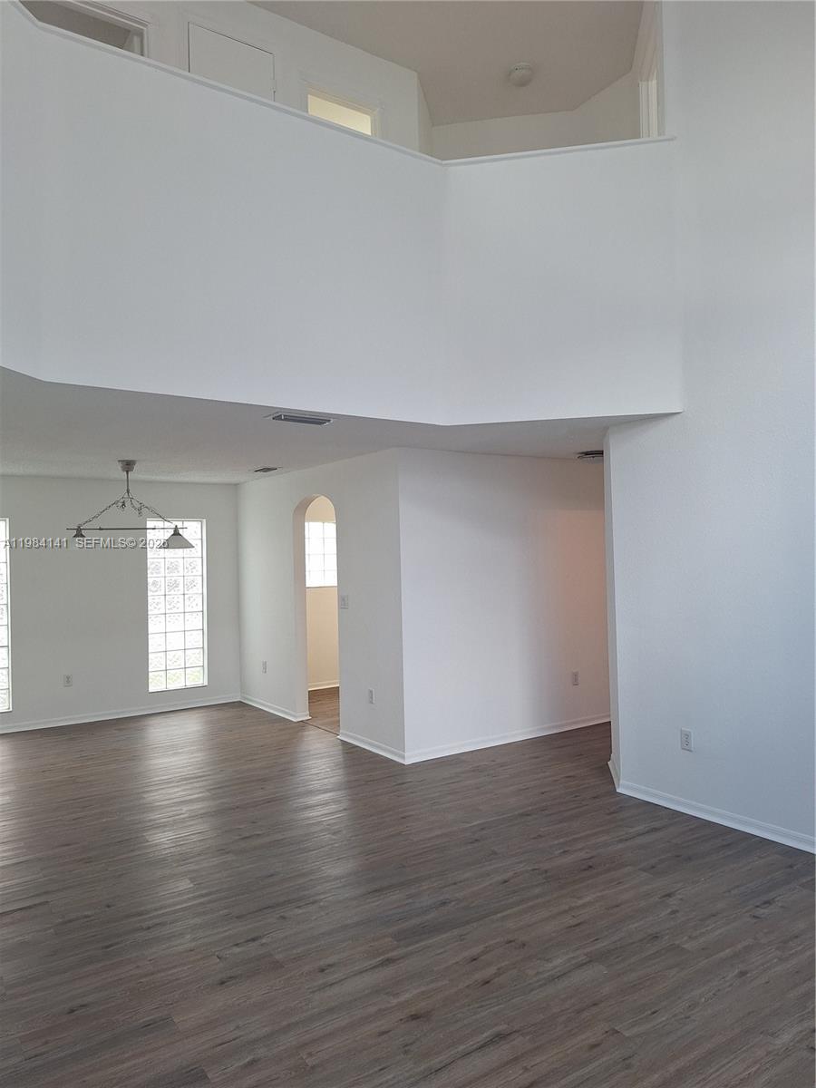 446 Lakeside Circle Sunrise, FL 33326 - Photo 2 of 13 a view of empty room with wooden floor and window