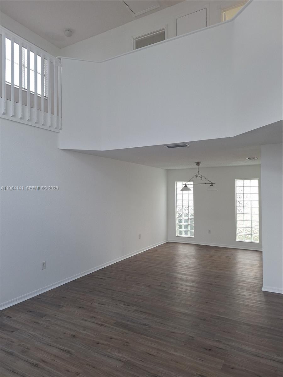 446 Lakeside Circle Sunrise, FL 33326 - Photo 3 of 13 a view of an empty room with window and wooden floor