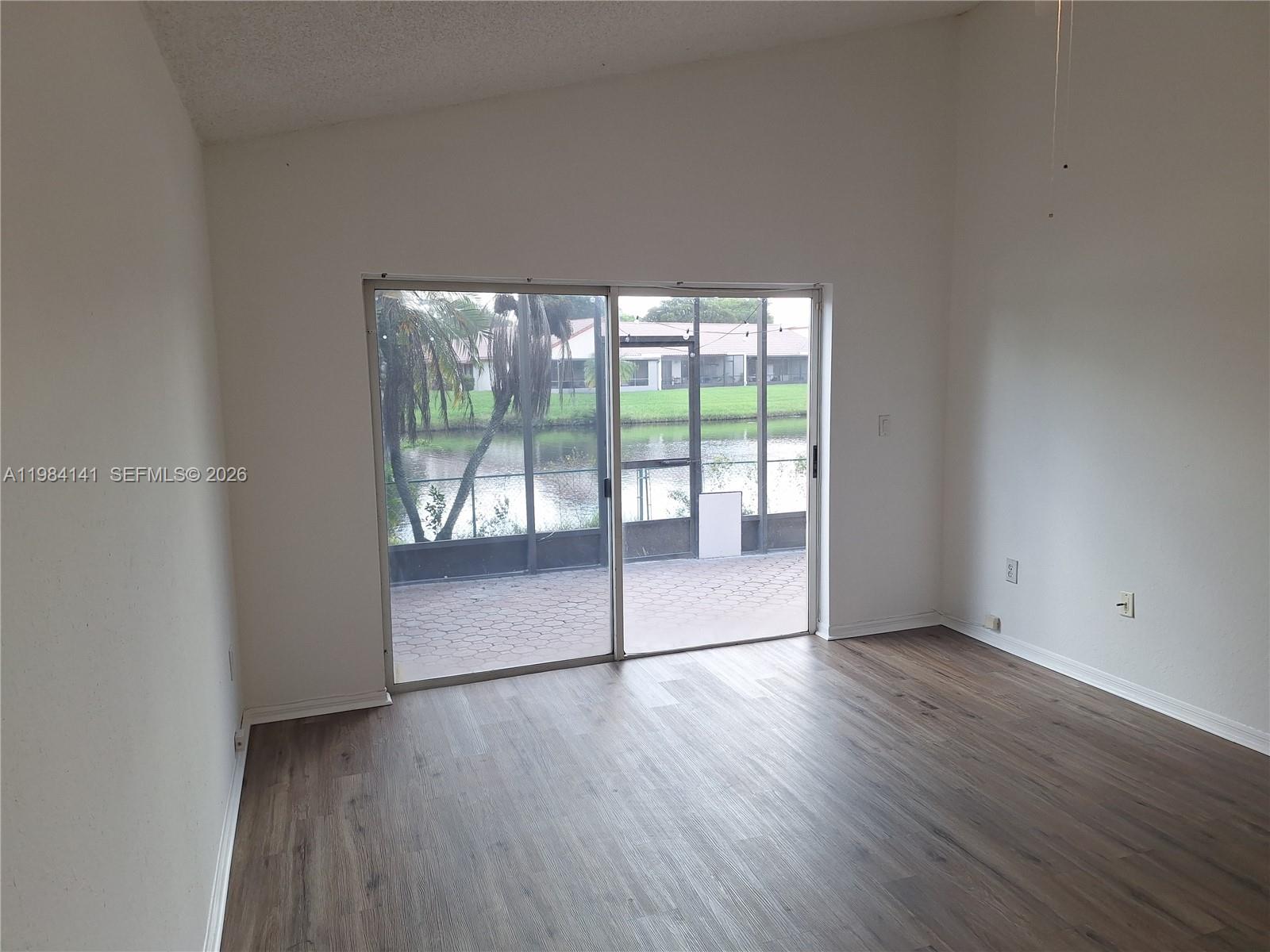 446 Lakeside Circle Sunrise, FL 33326 - Photo 4 of 13 an empty room with wooden floor and windows